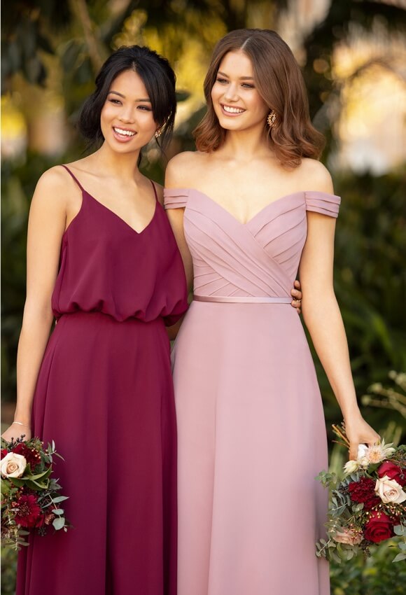 Bridesmaids wearing long evening dresses