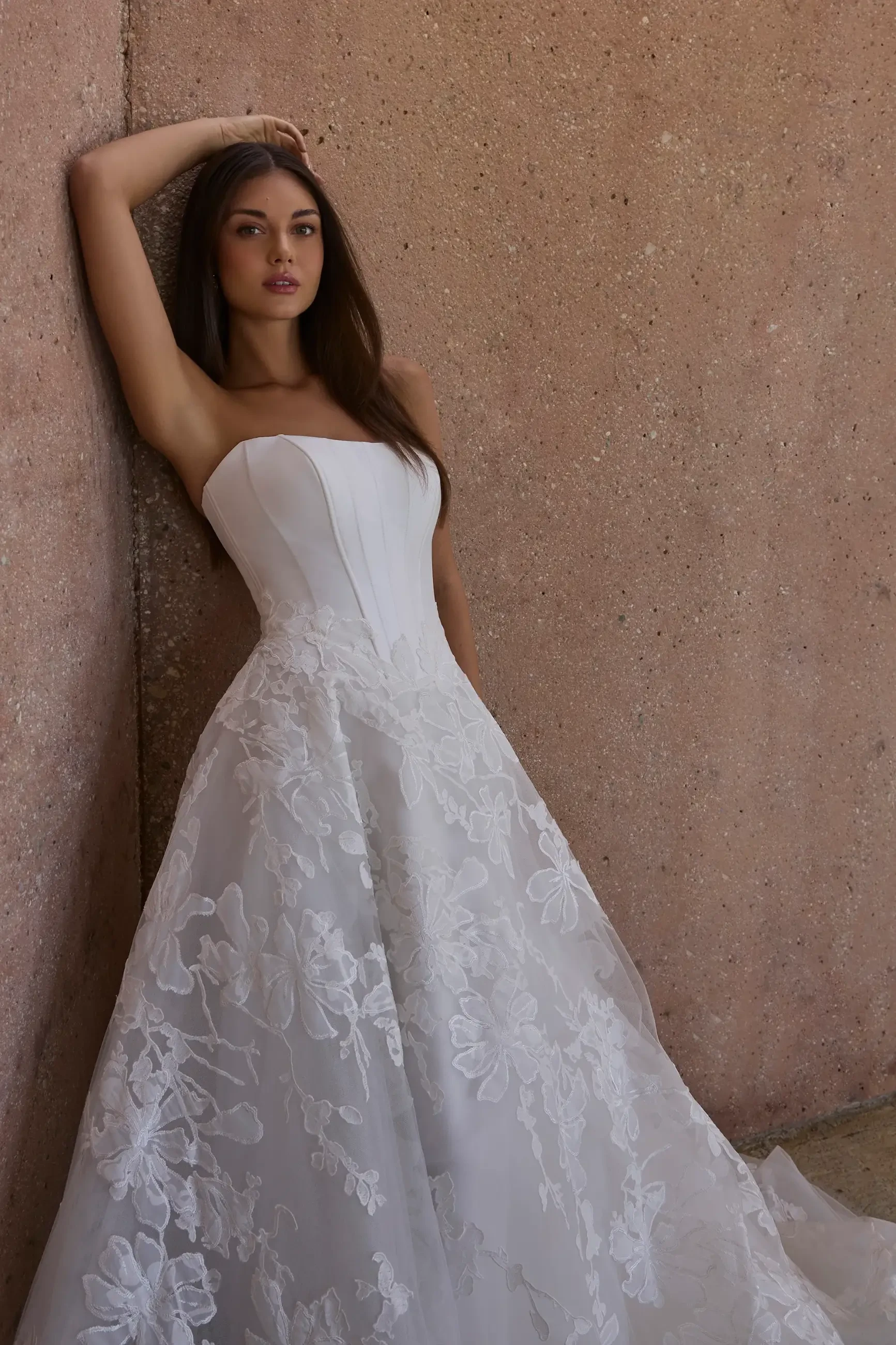 model is wearing a strapless a-line bridal gown