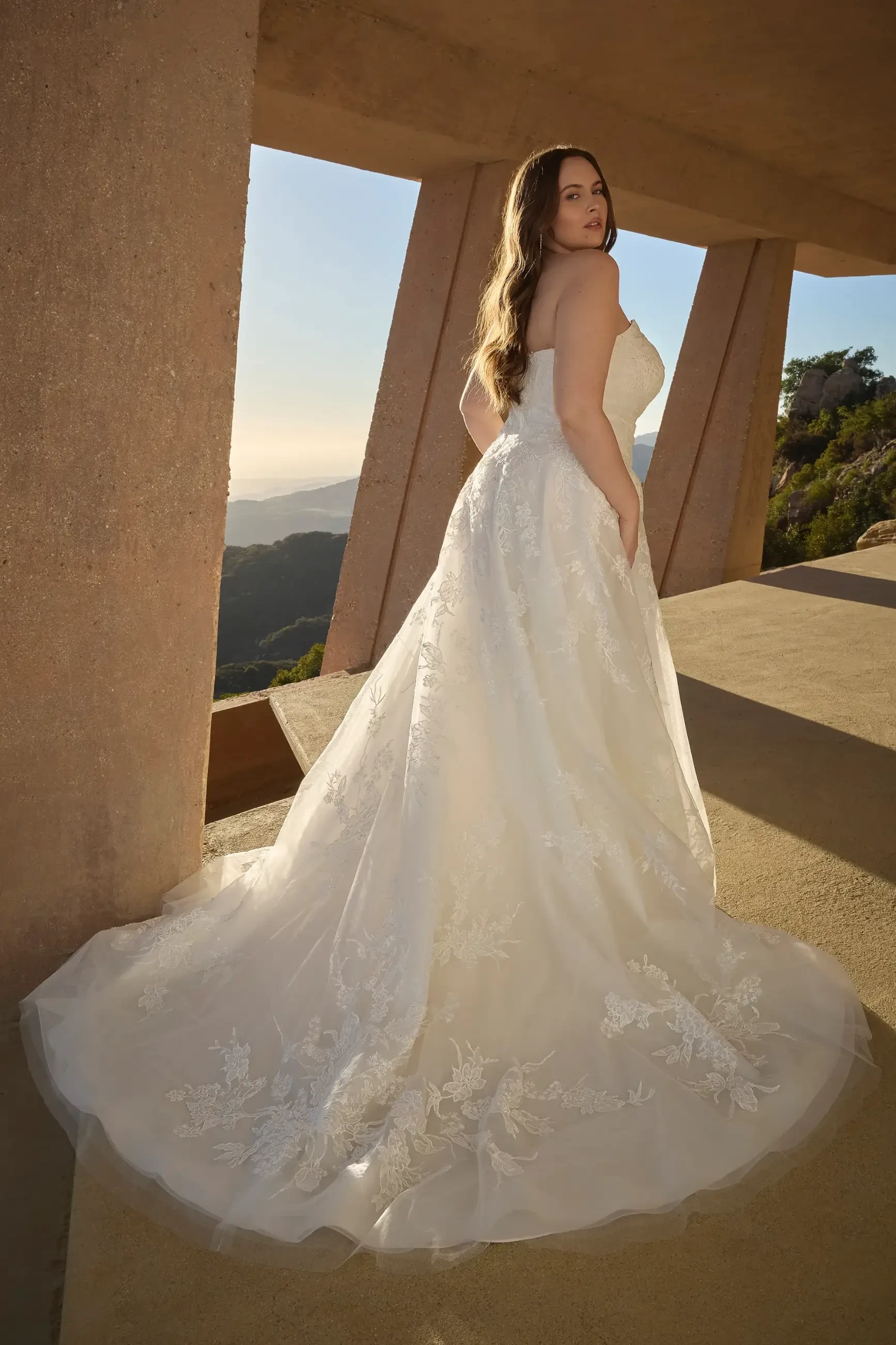 model is wearing a plus size lace bridal a-line dress