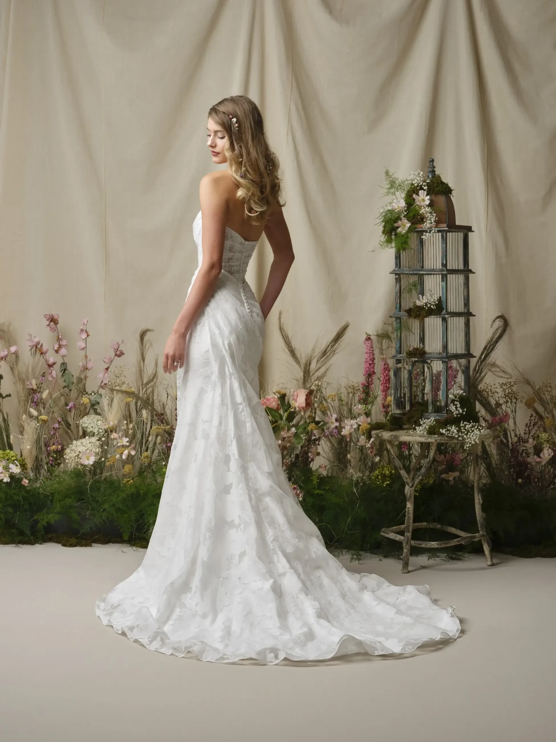 model is wearing a strapless wedding dress