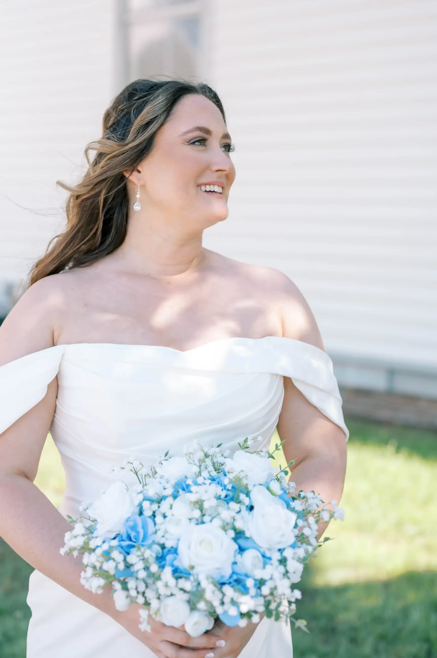 Virginia holding her wedding bouquet.
