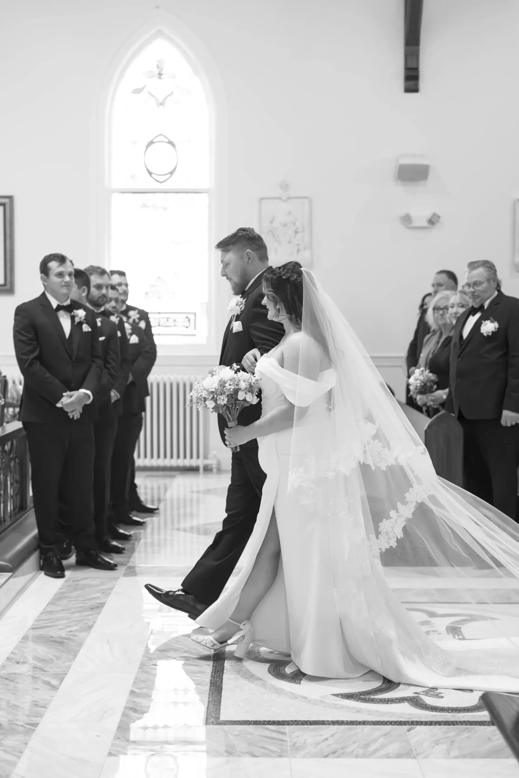 Virginia and James walking down the aisle together.