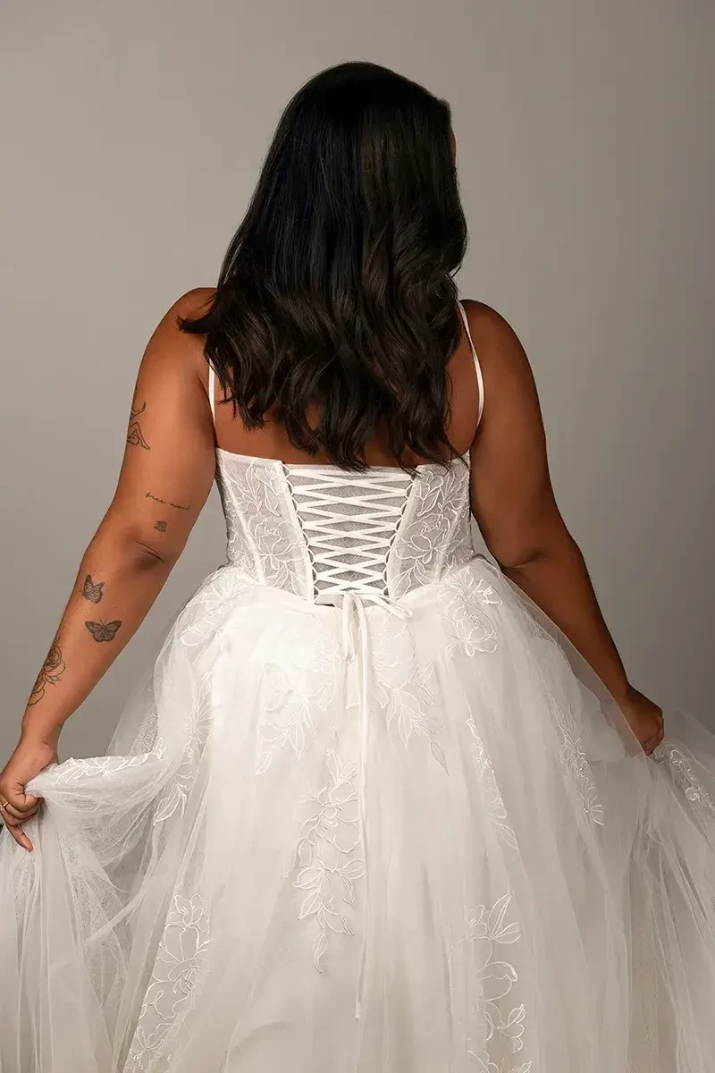 model is wearing a sleeveless tulle a-line wedding dress