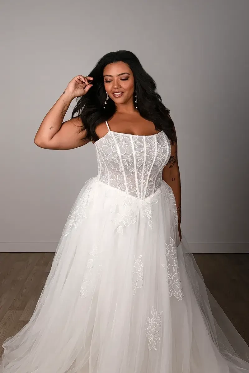 model is wearing a sleeveless tulle a-line wedding dress